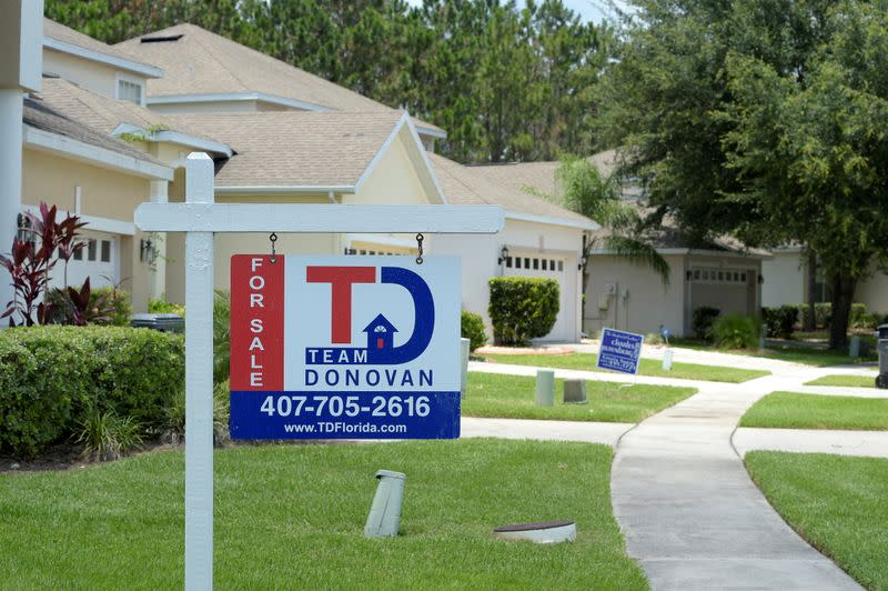 FILE PHOTO: For Sale signs stand in front of houses in a neighborhood where many British people have purchased homes