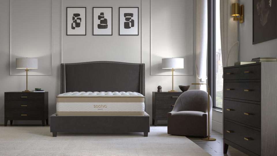 Image shows the Saatva RX mattress for back and joint pain placed on a luxury grey mattress in a stylish bedroom