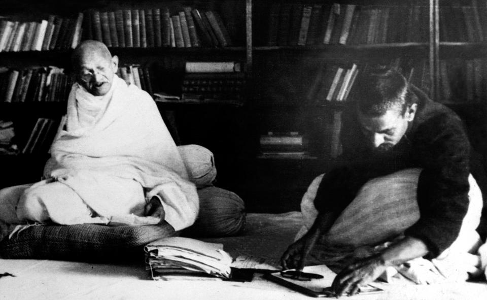 Picture dated 03 February 1940 of spiritual leader of India Mohandas Karamchand Gandhi (L), known as the Mahatma Gandhi (1869-1948), working with the president of the Work Congress in Allahabad. Founder of the Indian National Congress, he led the struggle for India's independence from British colonial rule. He was the pioneer of the resistance through mass civil disobedience, firmly founded upon total non-violence, which was one of the strongest driving philosophies of the Indian independence movement and inspired movements for civil rights and freedom across the world. He was assassinated by a Hindu fanatic. (Photo credit should read OFF/AFP via Getty Images)