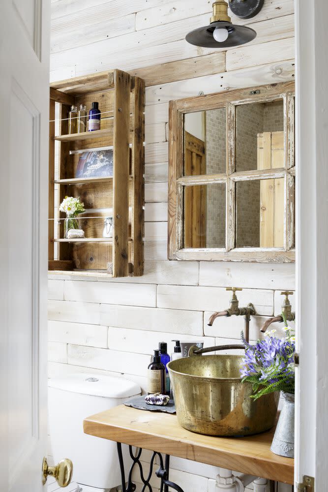 <p>Compromises do have to be made in <a href="https://www.countryliving.com/uk/homes-interiors/interiors/a40442005/small-space-design-tips/" rel="nofollow noopener" target="_blank" data-ylk="slk:small spaces;elm:context_link;itc:0;sec:content-canvas" class="link ">small spaces</a>, but it is possible to contain all of the necessary bathroom features – your sink, mirror, storage etc. – if you're willing to miniaturise. This clever shelving unit started life as an apple crate, whilst the tiny mirror hides some modest shelves. </p>