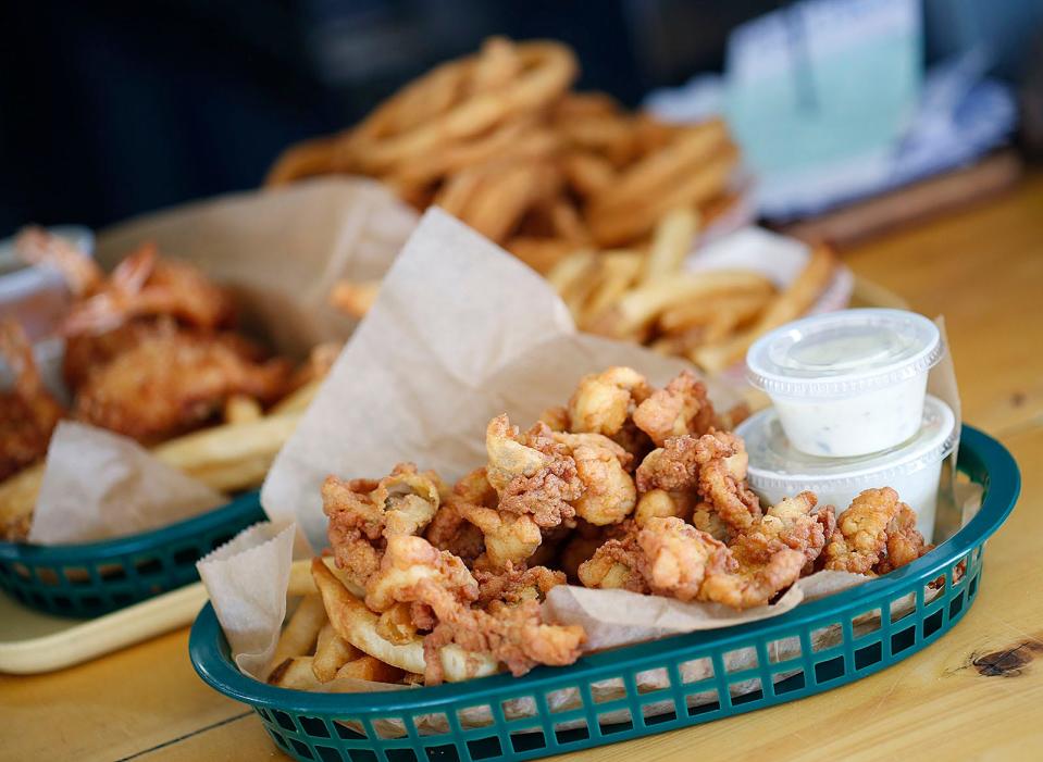 Sandy's serves batter-dipped fried clams with tartar sauce.