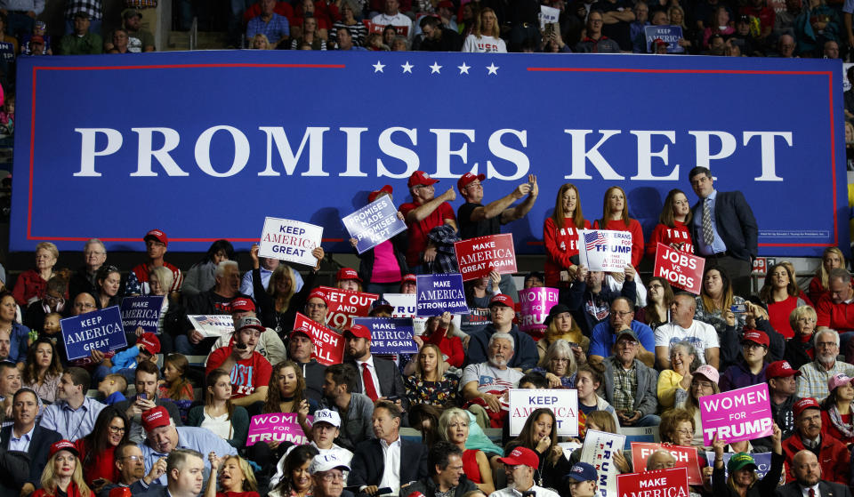 FILE - In this Nov. 5, 2018, file photo, supporters of President Donald Trump wait for him to arrive to speak at a rally at Allen County War Memorial Coliseum, in Fort Wayne, Ind. Vice President Mike Pence has a favorite line when he introduces President Donald Trump at rallies. He says "it's been three years of promises made and promises kept” under Trump. Is it true? The Associated Press reviewed what's happened with Trump's key campaign promises. (AP Photo/Carolyn Kaster, File)