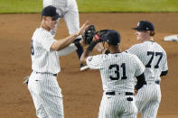 New York Yankees right fielder Aaron Judge, left, center fielder Aaron Hicks (31), and left fielder Clint Frazier (77) celebrate the Yankees 3-1 victory over the Atlanta Braves an interleague baseball game, Tuesday, April 20, 2021, at Yankee Stadium in New York. (AP Photo/Kathy Willens)