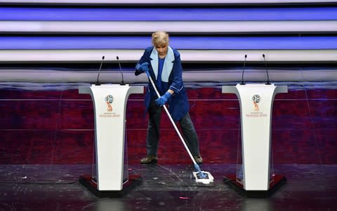 Staff cleans the stage - Credit: AFP