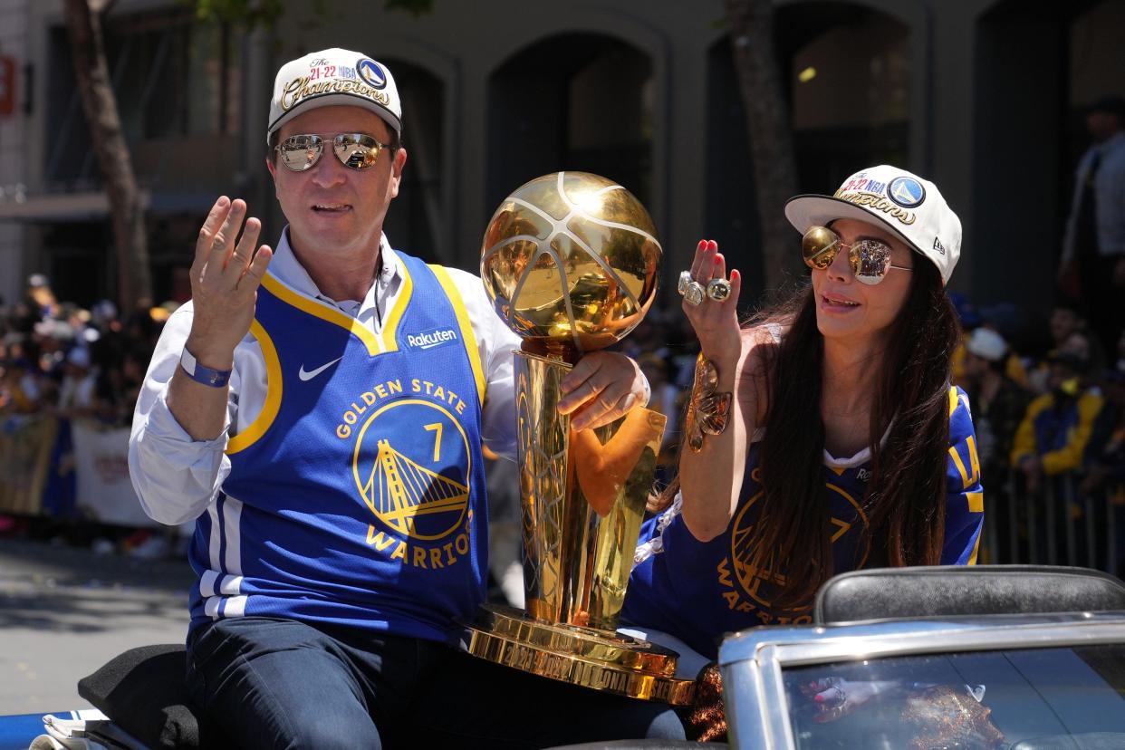 Golden State Warriors owner Joe Lacob, left, and wife Nicole Curran celebrate during the Golden State Warriors championship parade in downtown San Francisco on June 20, 2022. The Warriors have won four NBA championship since Lacob bought the team in 2010.