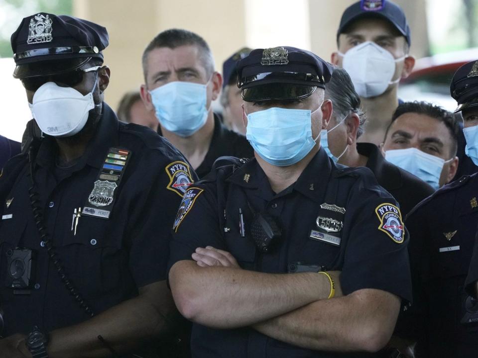 NYPD Police officers listen as Police Benevolent Association of the City of New York President Pat Lynch and representatives from other NYPD and law enforcement unions holds a news conference at the Icahn Stadium parking lot on June 9, 2020 to address the "current anti-law enforcement environment." in New York.