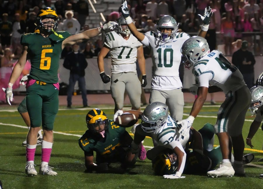 De La Salle’s Dom Gallwitz (10) signals Derrick (22) overtime winning touchdown as San Ramon’s Jack Horton contests it during their game at San Ramon Valley High School in Danville, Calif., on October. 13, 2023. (Ray Saint Germain/Bay City News)