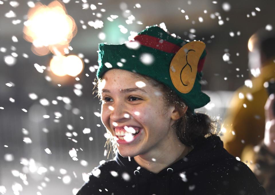 A Dickens of a Christmas is a Victorian holiday event that was held in downtown Spartanburg on Dec. 6. Jada Douglas. 16. of Broome High School lights up playing in the 'artificial' snow created for the night. 