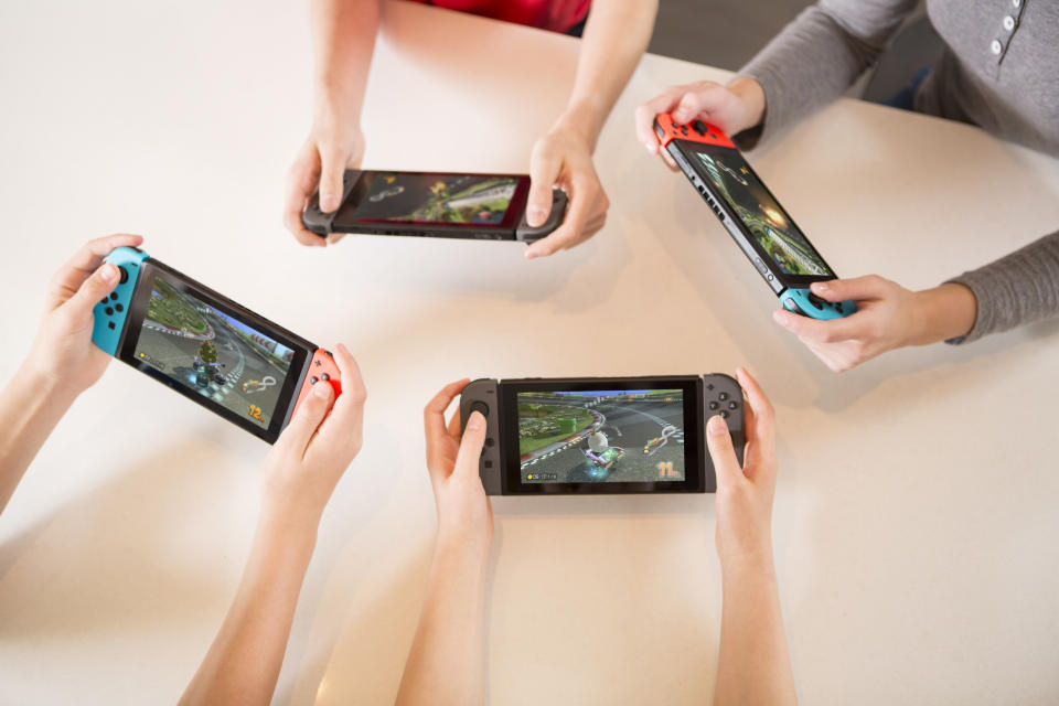 Kids playing Nintendo Switch consoles. Image courtesy of Nintendo.