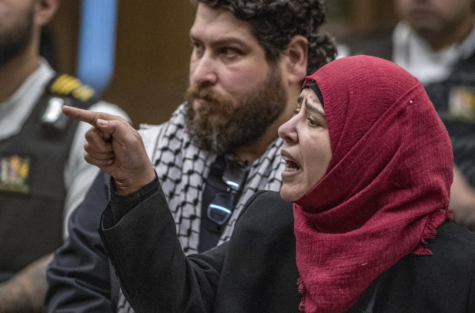Manal Dokhan gestures as she gives her victim impact statement during the sentencing hearing for Australian Brenton Harrison Tarrant at the Christchurch High Court after Tarrant pleaded guilty to 51 counts of murder, 40 counts of attempted murder and one count of terrorism in Christchurch, New Zealand, Wednesday, Aug. 26, 2020. More than 60 survivors and family members will confront the New Zealand mosque gunman this week when he appears in court to be sentenced for his crimes in the worst atrocity in the nation's modern history. (John Kirk-Anderson/Pool Photo via AP)