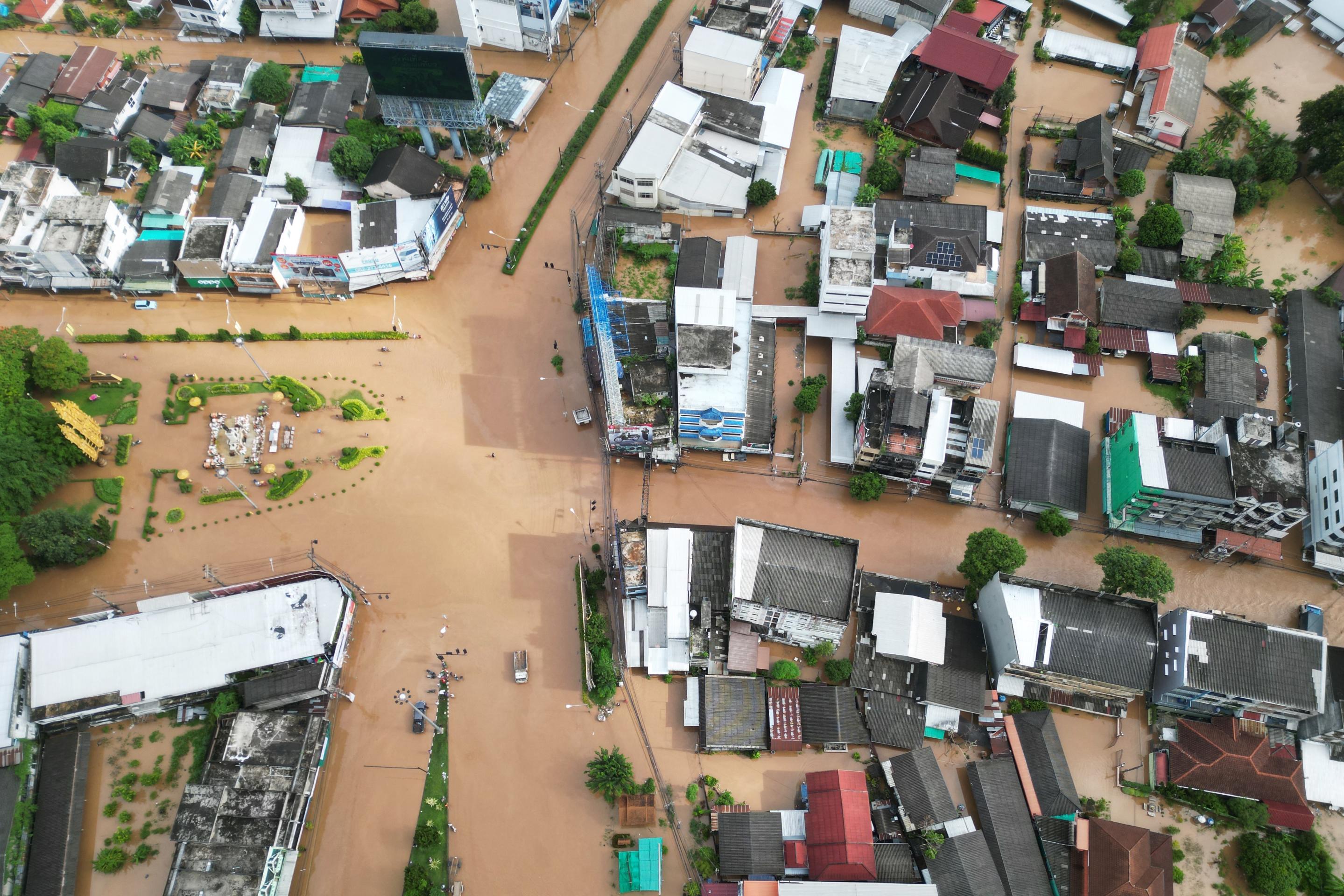 This aerial photo taken on Sept. 12, 2024, shows floodwaters surrounding homes in the northern Thai city of Chiang Rai. Thai authorities said at least four people were killed in the northern provinces of Chiang Mai and Chiang Rai and that the military had been deployed to help about 9,000 families affected by flooding. (Lillian Suwanrumpha/AFP via Getty Images)