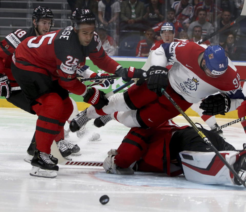 Canada's Daniell Nurse checks Czech Republic's Radek Faksa, from left, during the Ice Hockey World Championships semifinal match between Canada and Czech Republic at the Ondrej Nepela Arena in Bratislava, Slovakia, Saturday, May 25, 2019. (AP Photo/Ronald Zak)