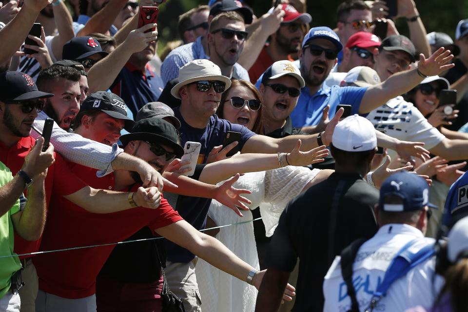 Fans reacts as Tiger Woods, right, walks to the sixth tee during the third round of the Dell Technologies Championship golf tournament at TPC Boston in Norton, Mass., Sunday, Sept. 2, 2018. (AP Photo/Michael Dwyer)