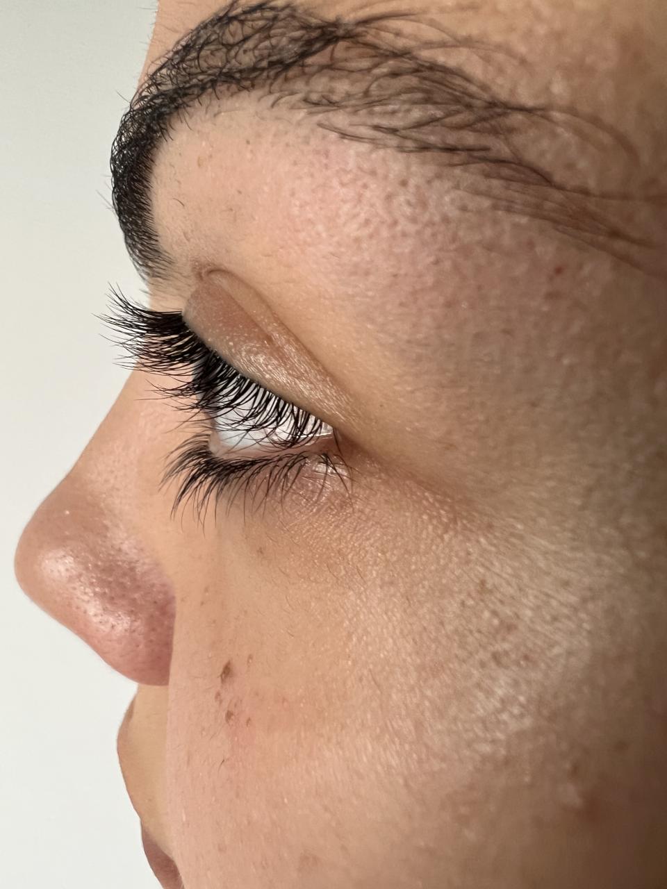 Woman showing black eyelashes and brows