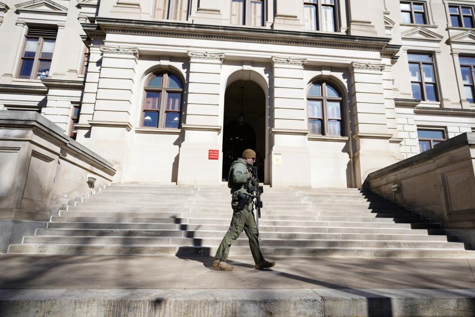 Georgia State Patrol guard walks on the steps outside the Georgia Capitol in Atlanta.