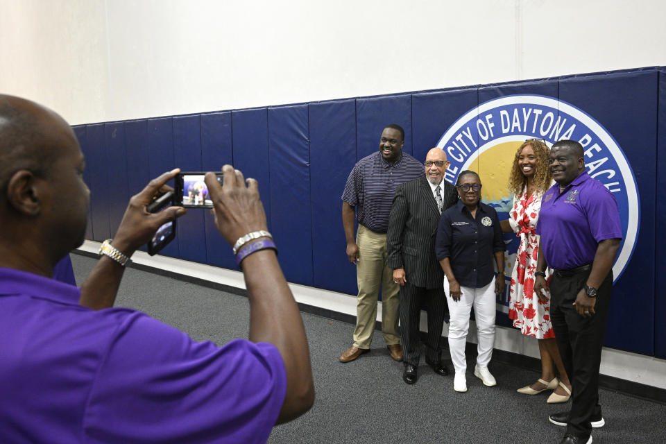 Kelvin G. Mayner, right, poses for a photo with panelists Genesis Robinson, from left, Rodney Hurst, Cynthia Slater and Mary Davis Johnson during the Voters Education 2024 Community Forum, addressing the Florida Legislature's voter suppression tactics, Thursday, May 16, 2024, in Daytona Beach, Fla. Laws passed in several Republican-controlled states are making it challenging for advocates to adapt as they try to register and educate potential voters with just months to go before the presidential election. (AP Photo/Phelan M. Ebenhack)