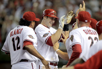 Arizona manager Kirk Gibson (right) greets Goldschmidt as he returns to the dugout following his fifth-inning grand slam