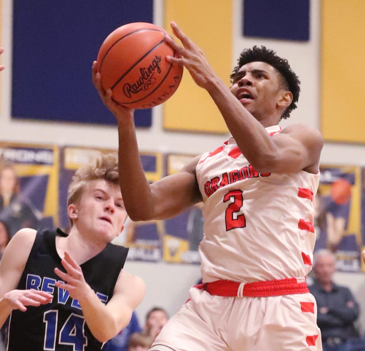 East's Mike Woodall gets to the basket as Revere's Baron Bania looks on during the Div. II district semifinal boys basketball game at North Ridgeville Academic Center on Thursday.