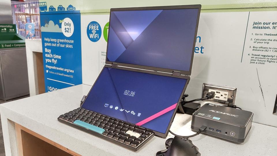 A mini PC with a portable monitor set up at the airport