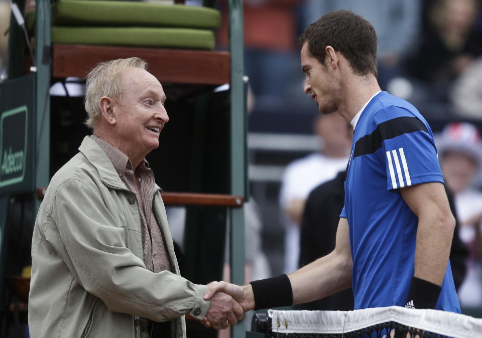 Tennis Hall-of-Famer Rod Laver, who won 11 Grand Slam titles and 200 tournaments, shakes hands with Britain's Andy Murray prior to flipping the coin for Murray's Davis Cup match against Donald Young, of the United States, Friday, Jan. 31, 2014, in San Diego. (AP Photo/Lenny Ignelzi)