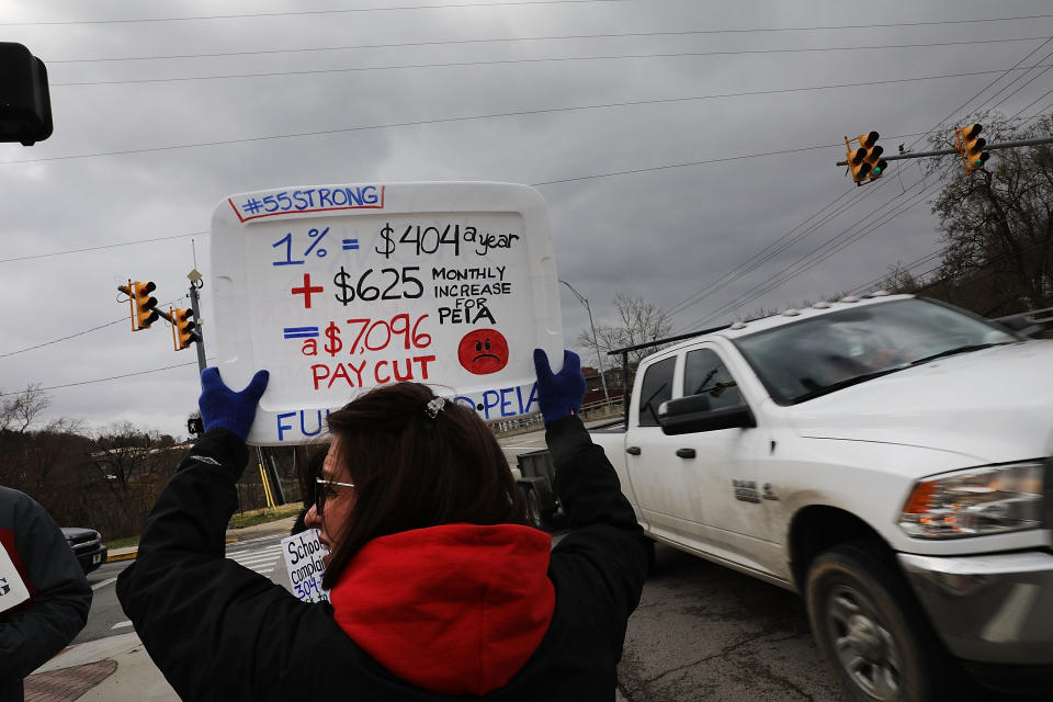 <p>West Virginia teachers, students and supporters hold signs on a Morgantown street as they continue their strike on March 2, 2018 in Morgantown, W.Va. (Photo: Spencer Platt/Getty Images) </p>