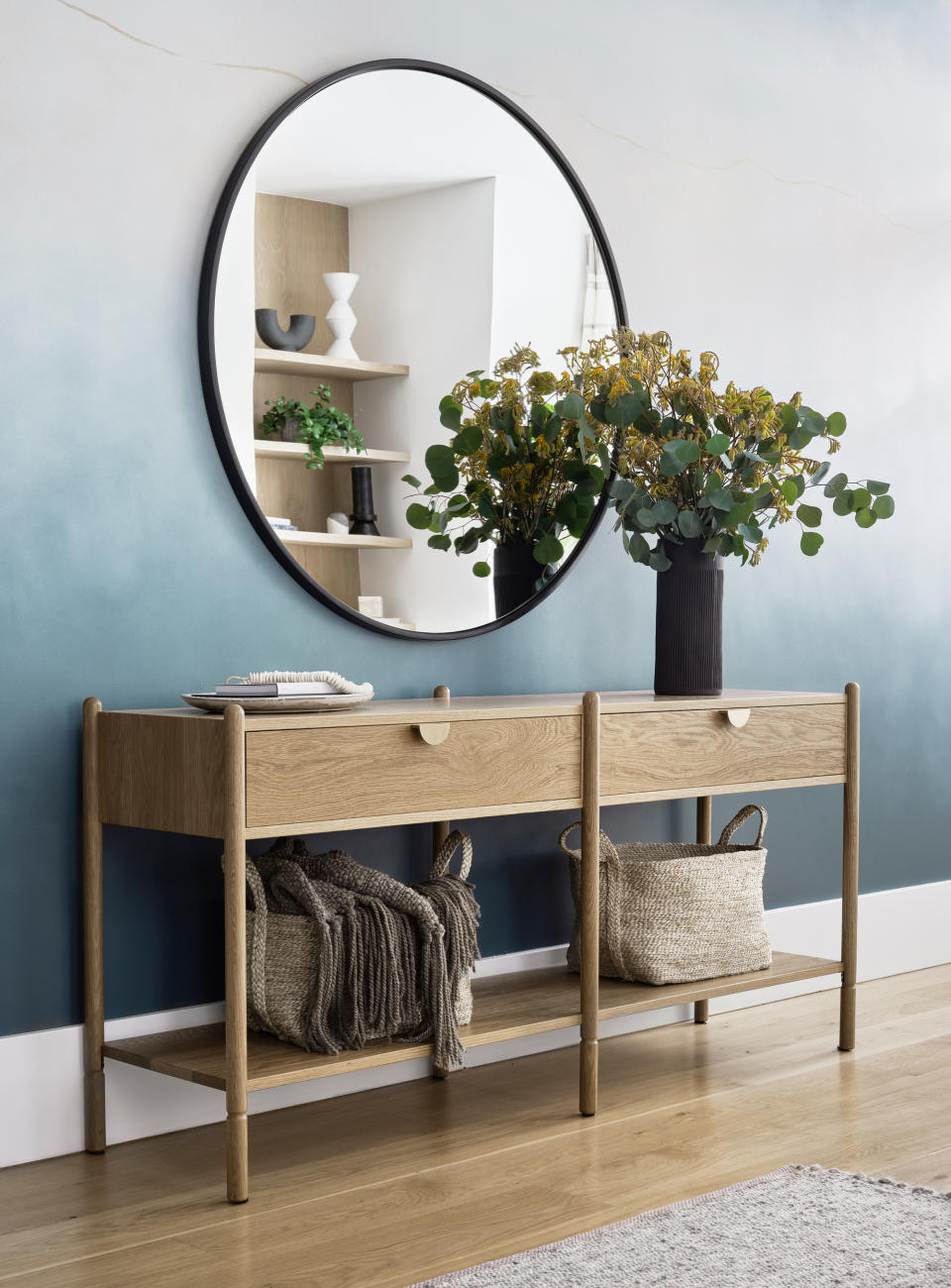 a sideboard against a gradient wall