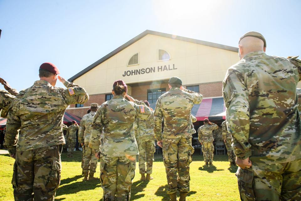 Soldiers salute during a Group Support Battalion, 3rd Special Forces Group building dedication ceremony in honor of Sgt. 1st Class Jeremiah Johnson on Tuesday, Oct. 4, 2022. Johnson is one of the soldiers killed Oct. 4, 2017, in Niger. 