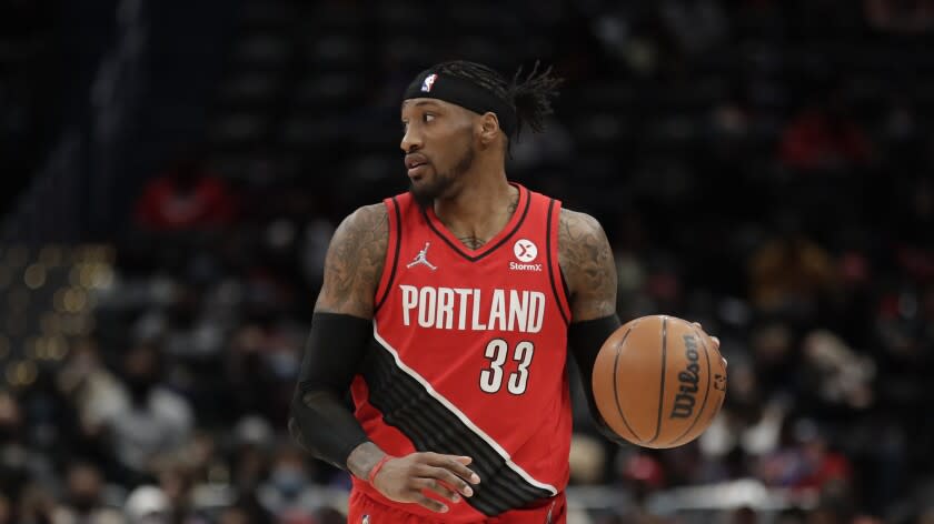 Portland Trail Blazers' Robert Covington moves the ball during the second half of an NBA basketball game against the Washington Wizards, Saturday, Jan. 15, 2022, in Washington. (AP Photo/Luis M. Alvarez)