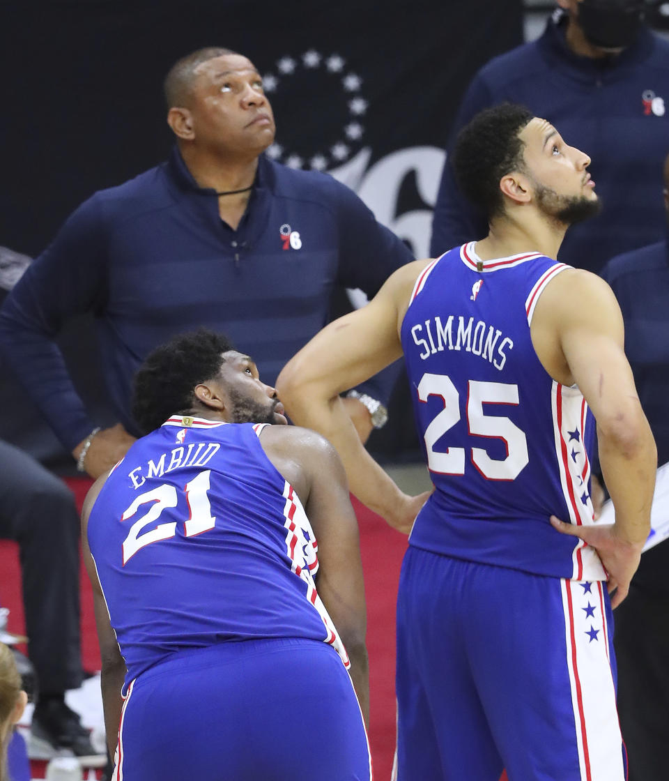 Philadelphia 76ers center Joel Embiid, head coach Doc Rivers, and guard Ben Simmons look at the clock during a time out after Embiid missed both his free throws with 10 seconds left in game 5 during a 109-106 loss to the Atlanta Hawks in their NBA Eastern Conference semifinals series on Wednesday, Jun 16, 2021, in Philadelphia. (Curtis Compton/Atlanta Journal-Constitution via AP)