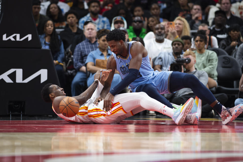 Memphis Grizzlies forward Jaren Jackson Jr. fouls Atlanta Hawks forward Onyeka Okongwu during the second half of an NBA basketball game, Sunday, March 26, 2023, in Atlanta. (AP Photo/Hakim Wright Sr.)