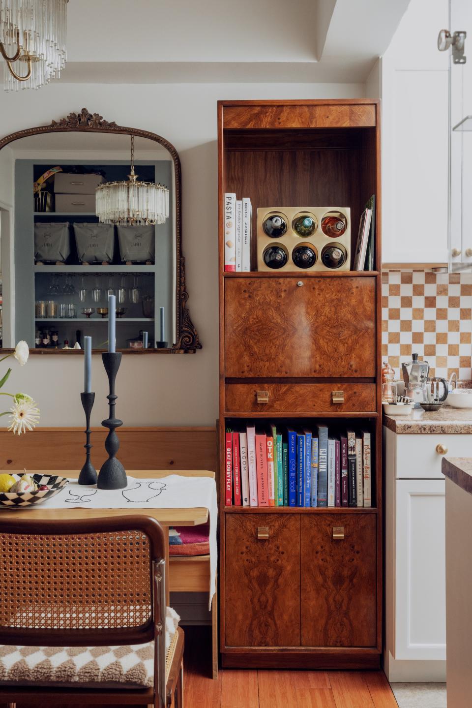 The burl wood drop-down cabinet is an Etsy find.