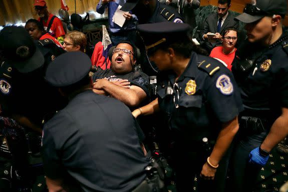 Capitol Police arrest a demonstrator for reportedly disrupting the hearing.