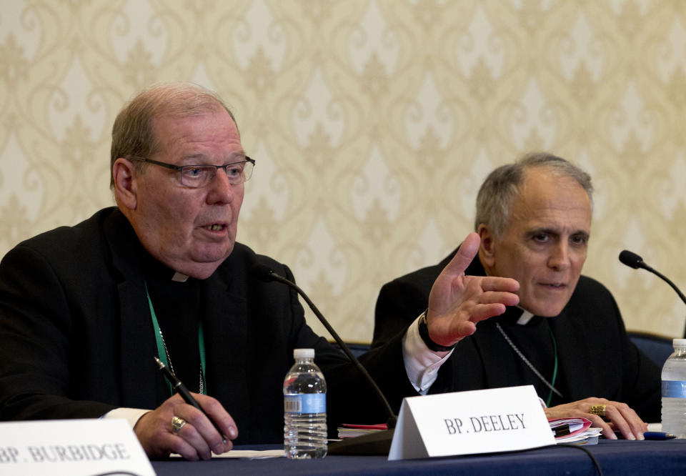 Robert Deeley, left, Bishop of the Diocese of Portland, accompanied by Cardinal Daniel DiNardo, of the Archdiocese of Galveston-Houston and President of the United States Conference of Catholic Bishops (USCCB), speaks during a news conference at the United States Conference of Catholic Bishops (USCCB), 2019 Spring meetings in Baltimore, Md., Tuesday, Jun 11, 2019. (AP Photo/Jose Luis Magana)
