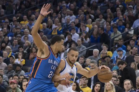 January 18, 2017; Oakland, CA, USA; Golden State Warriors guard Stephen Curry (30) dribbles the basketball against Oklahoma City Thunder forward Andre Roberson (21) during the second quarter at Oracle Arena. Mandatory Credit: Kyle Terada-USA TODAY Sports