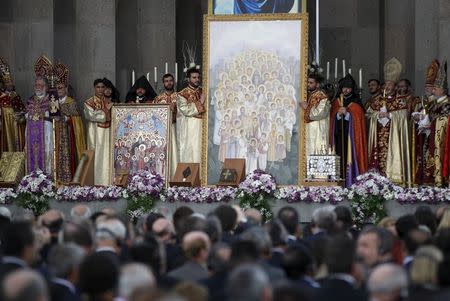 Priests attend a canonisation ceremony for the victims of mass killings of Armenians by Ottoman Turks at the open-air altar of Armenia's main cathedral in Echmiadzin April 23, 2015. REUTERS/David Mdzinarishvili