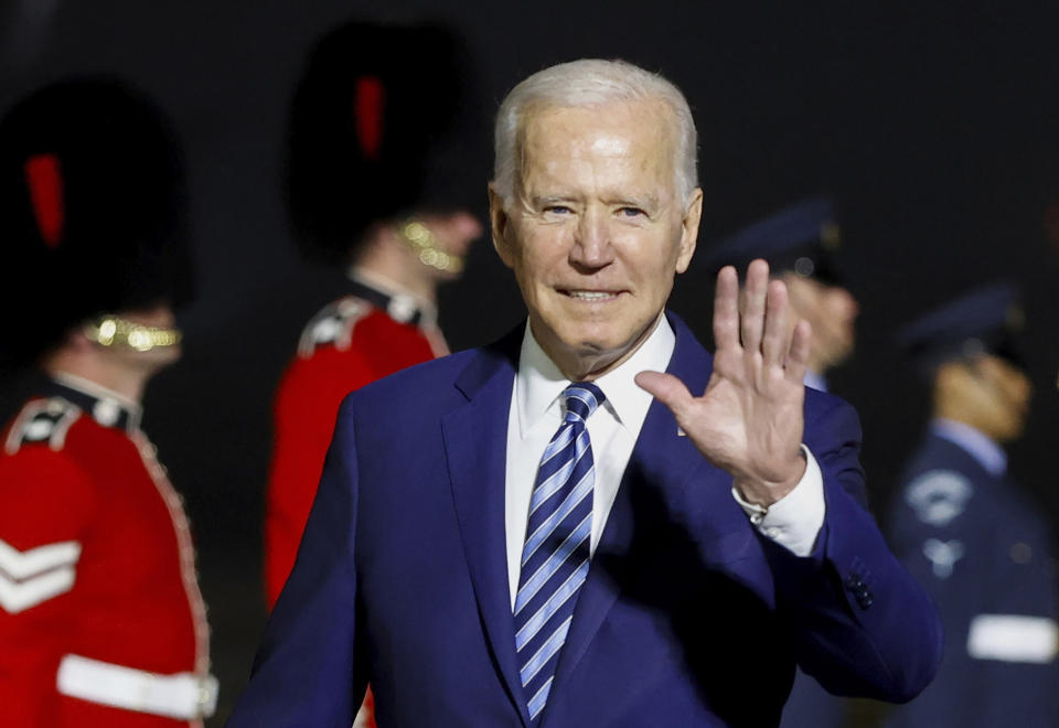 U.S. President Joe Biden waves on his arrival on Air Force One at Cornwall Airport Newquay, in Newquay, England, ahead of the G7 summit, Wednesday, June 9, 2021. (Phil Noble/Pool Photo via AP)