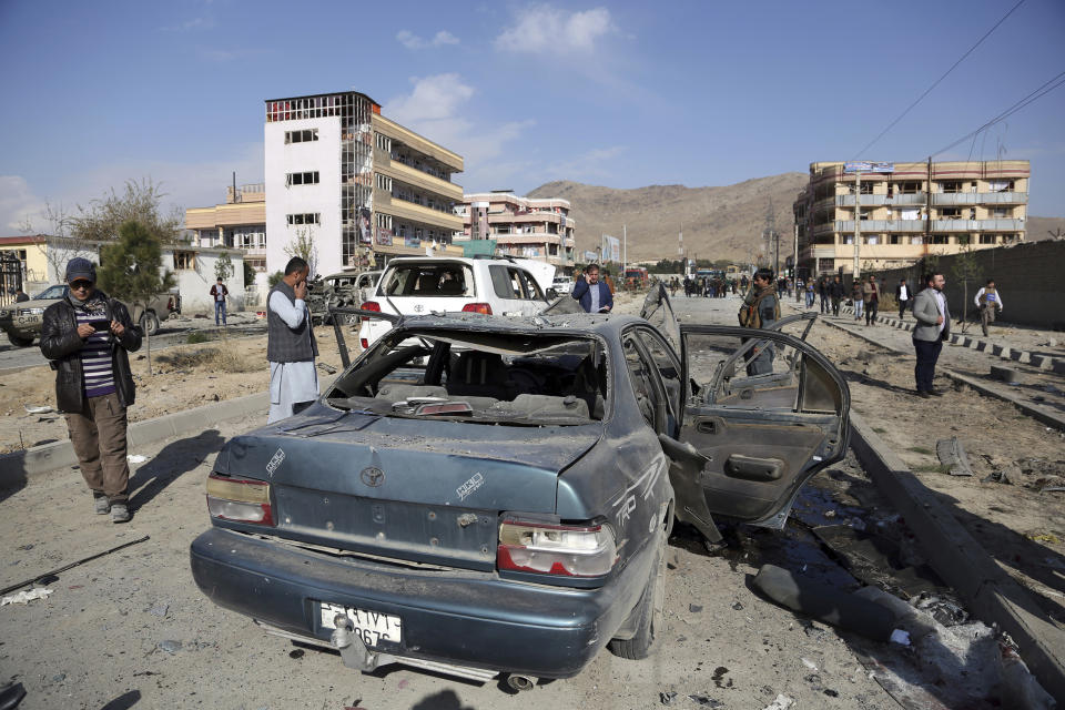 Afghan security personnel gather at the site of a car bomb attack in Kabul, Afghanistan, Wednesday, Nov. 13, 2019. A car bomb detonated in the Afghan capital of Kabul during Wednesday's morning commute, killing several people, officials said. (AP Photo/Rahmat Gul)