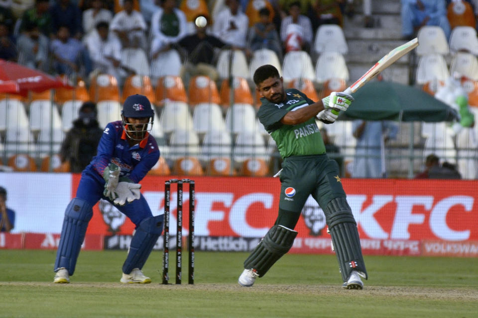 Pakistan's Babar Azam, right, plays a shot as Nepal's Aasif Sheikh watches during the one-day international cricket match of Asia Cup between Pakistan and Nepal, in Multan, Pakistan, Wednesday, Aug. 30, 2023. (AP Photo/Asim Tanveer)