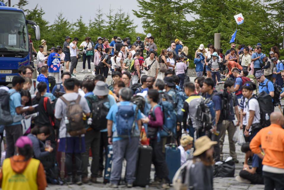 Tourists emerge from and wait for buses at Mt. Fuji's 5th station, in an image provided by the Yamanashi prefecture administration. / Credit: Handout/Yamanashi prefecture