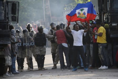 Protesters try to pass the police cordon during a demonstration to demand the resignation of Haitian president Jovenel Moise, in the streets of Petion Ville, Port-au-Prince