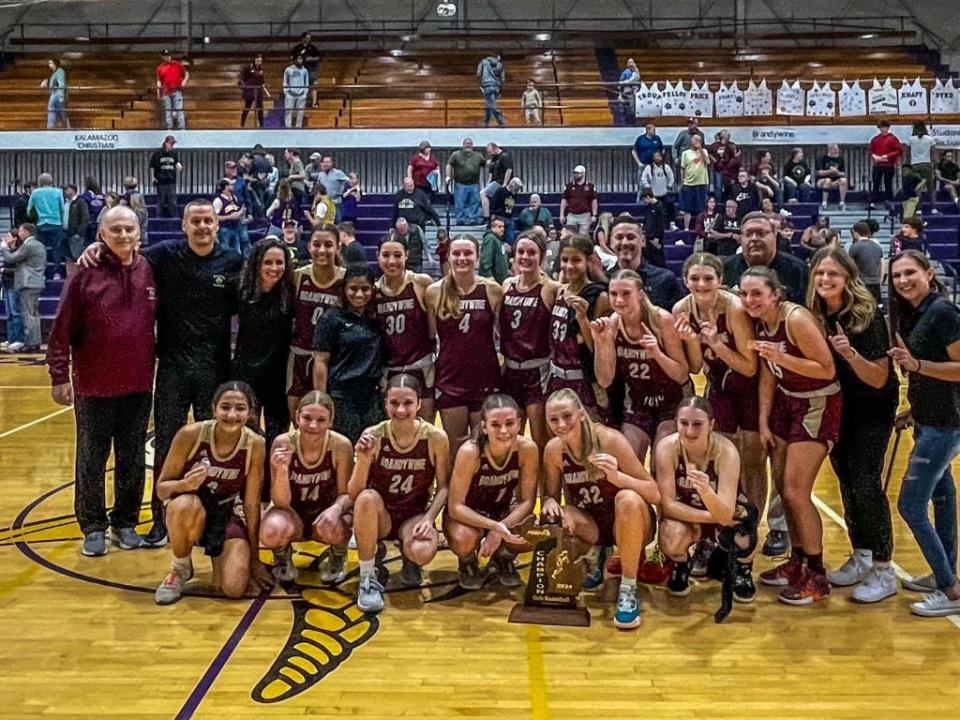 The Brandywine girls basketball team takes a photo after beating Kalamazoo Christian, 59-42, in an MHSAA Division 3 regional championship game Wednesday, March 13, 2024, at Bronson High School.