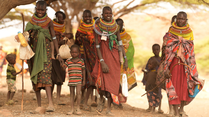 Villagers, mostly women and children, gather under a tree in Purapul village, Loiyangalani area, during World Vision-supported health interventions that help communities tackle malnutrition and other health problems caused by drought, in northern Kenya - Tuesday 12 July 2022