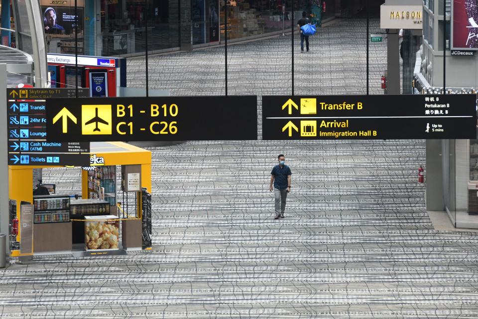 A man walks along the transit area at Changi International Airport terminal in Singapore on June 8, 2020, as Singapore prepares to reopen its borders after shutting them to curb the spread of the COVID-19 novel coronavirus. (Photo by Roslan RAHMAN / AFP) (Photo by ROSLAN RAHMAN/AFP via Getty Images)