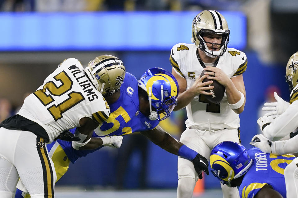 New Orleans Saints quarterback Derek Carr (4) is sacked by Los Angeles Rams linebacker Ernest Jones left, during the first half of an NFL football game Thursday, Dec. 21, 2023, in Inglewood, Calif. (AP Photo/Ryan Sun)