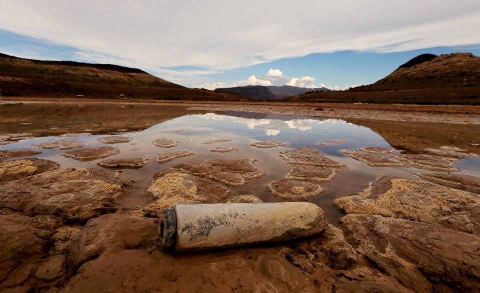 Clouds are reflected on the surface of a pool that is separated from the main body of water in Lake Mead.