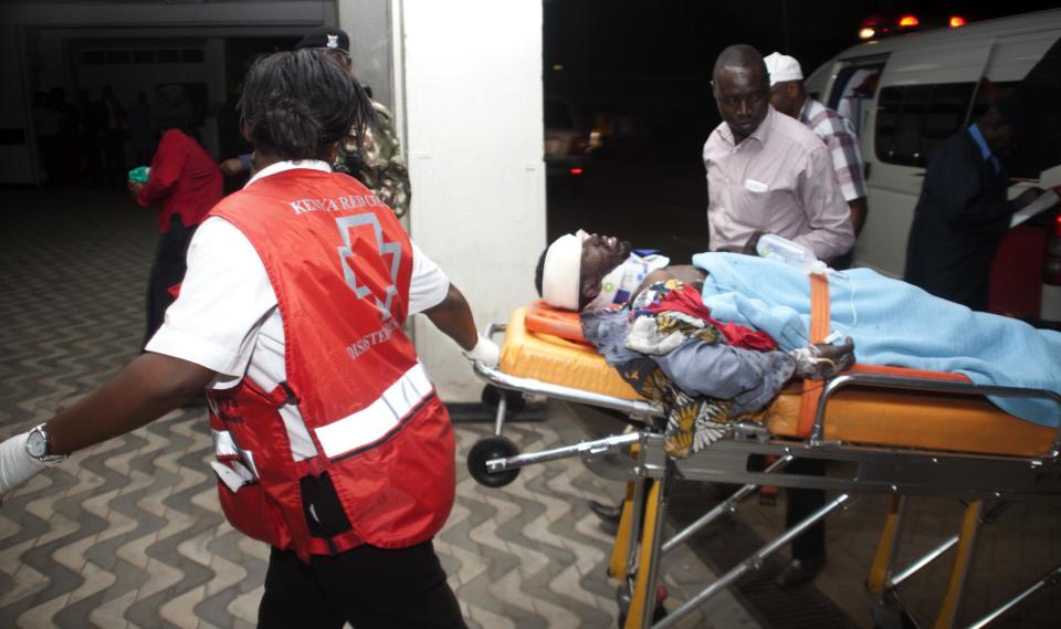 An injured Kenyan is wheeled into Kenyatta National Hospital in Nairobi, Kenya, Monday March 31, 2014, after an explosion in downtown Nairobi killed at least five people. The National Disaster Operation Center said on Twitter that explosions had occurred Monday evening in a neighborhood known for its large Somali population, and the agency said five people were killed and several injured without saying what caused the blasts. (AP Photo/Sayyid Azim)