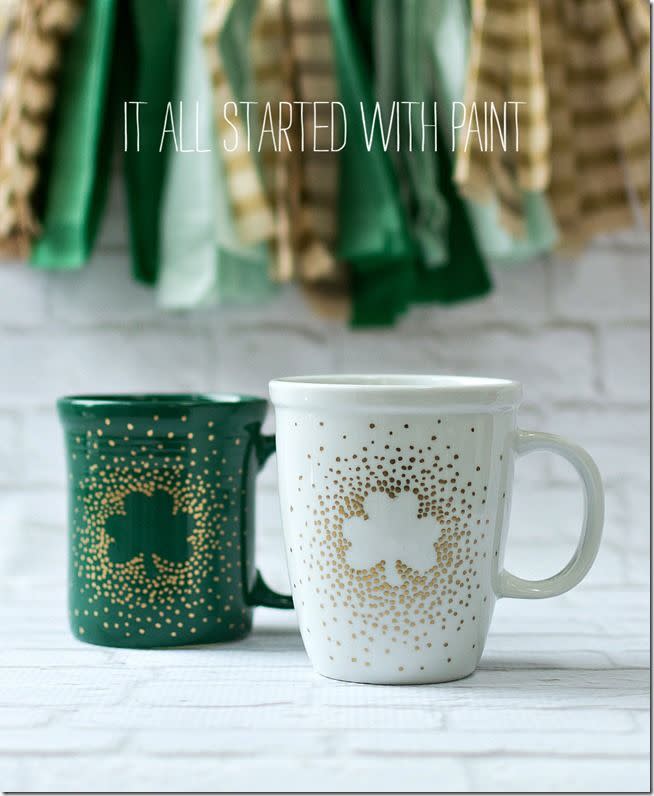 a couple of green and white coffee cups on a white surface