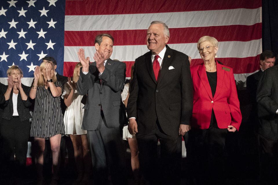 Georgia Gov. Nathan Deal, second from right, is introduced to applause from Republican gubernatorial nominee and Secretary of State Brian Kemp, third from left, during a unity rally, Thursday, July 26, 2018, in Peachtree Corners, Ga. (AP Photo/John Amis)