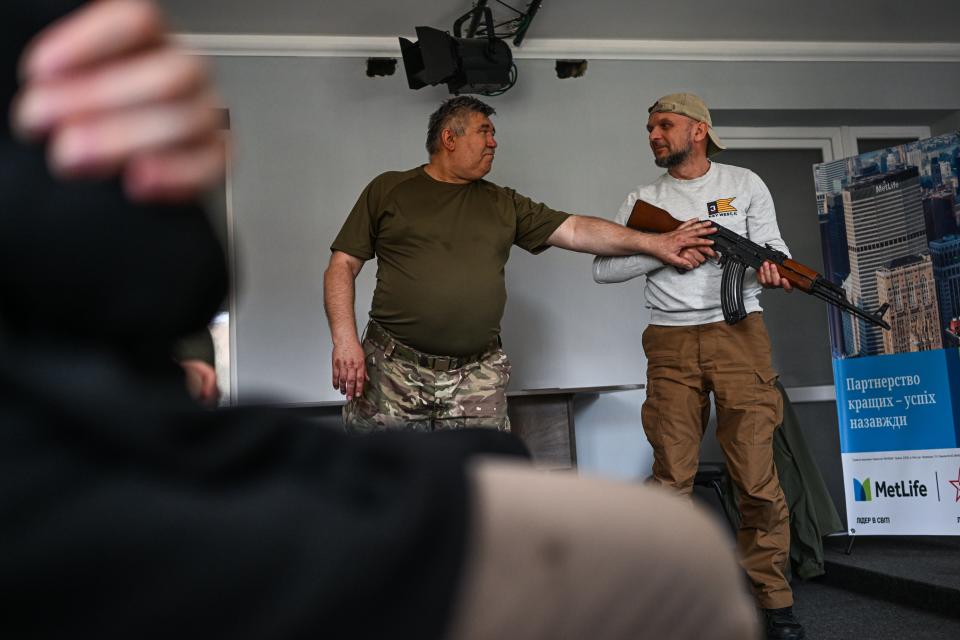 A Ukrainian man holds a Kalashnikov rifle during in a weapon training (Anadolu Agency via Getty Images)