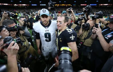 Jan 13, 2019; New Orleans, LA, USA; Philadelphia Eagles quarterback Nick Foles (9) and New Orleans Saints quarterback Drew Brees (9) meet after a NFC Divisional playoff football game at Mercedes-Benz Superdome. The Saints won 20-14. Mandatory Credit: Chuck Cook-USA TODAY Sports